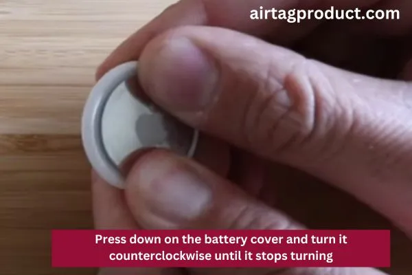 AirTag Open: Press down on the battery cover and turn it counterclockwise until it stops turnin